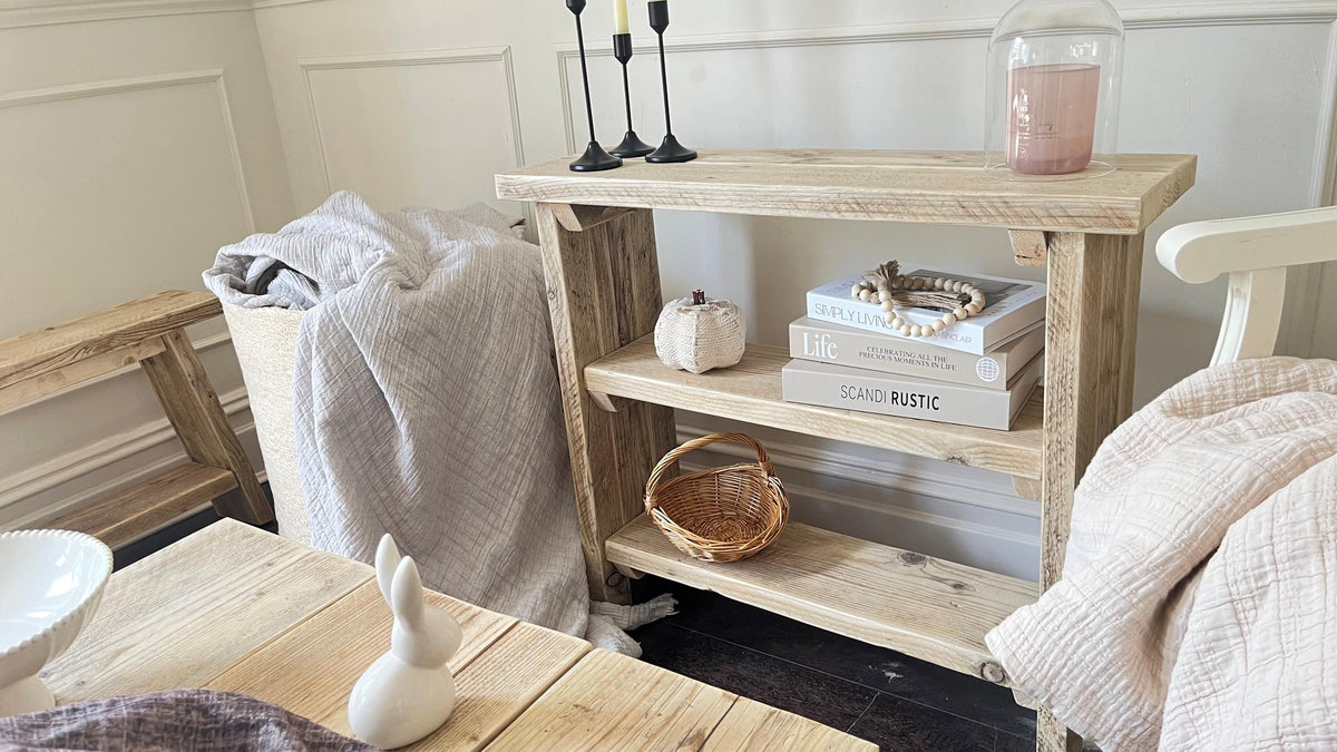 A farmhouse styled, rustic wooden bookcase, in a living room setting. (front view)