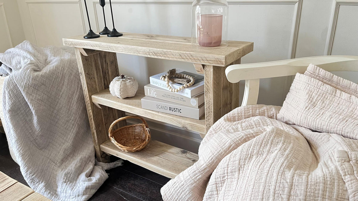 A farmhouse styled, rustic wooden bookcase, in a living room setting. (front view)