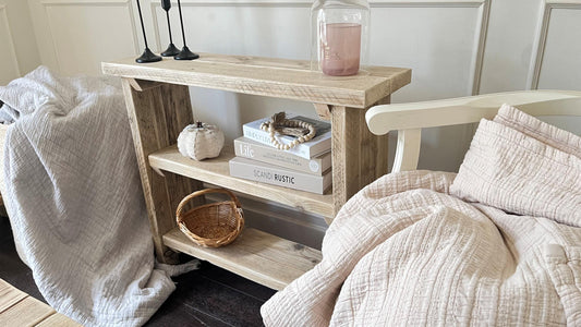 A farmhouse styled, rustic wooden bookcase, in a living room setting. (front view)