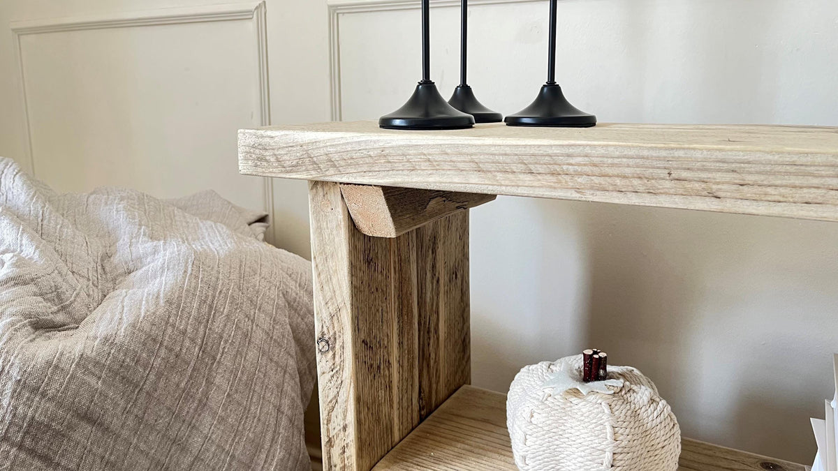 Close up of a farmhouse styled, rustic wooden bookcase, in a living room setting. (front view)