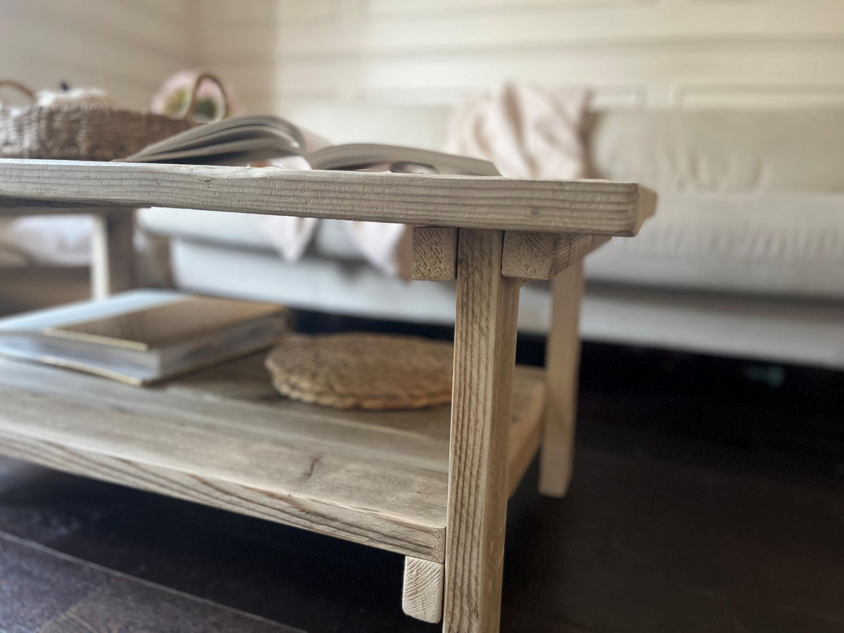 Farmhouse style wooden coffee table with lower shelf.