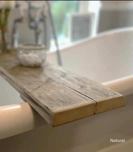 Rustic wooden bathtub tray on a bathtub with a blurred background