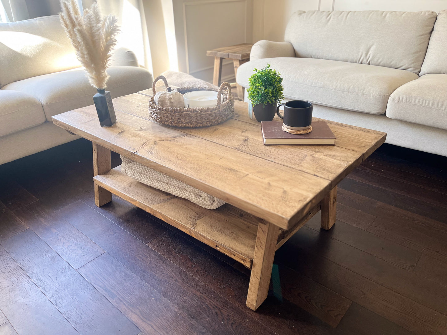 Wooden coffee table in a living room with decor items on top