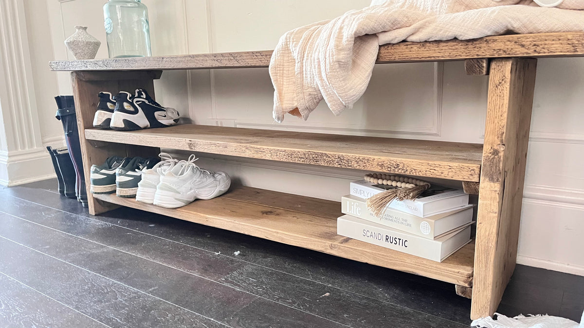A farmhouse styled, rustic wooden show rack, in an entryway setting. (front view)