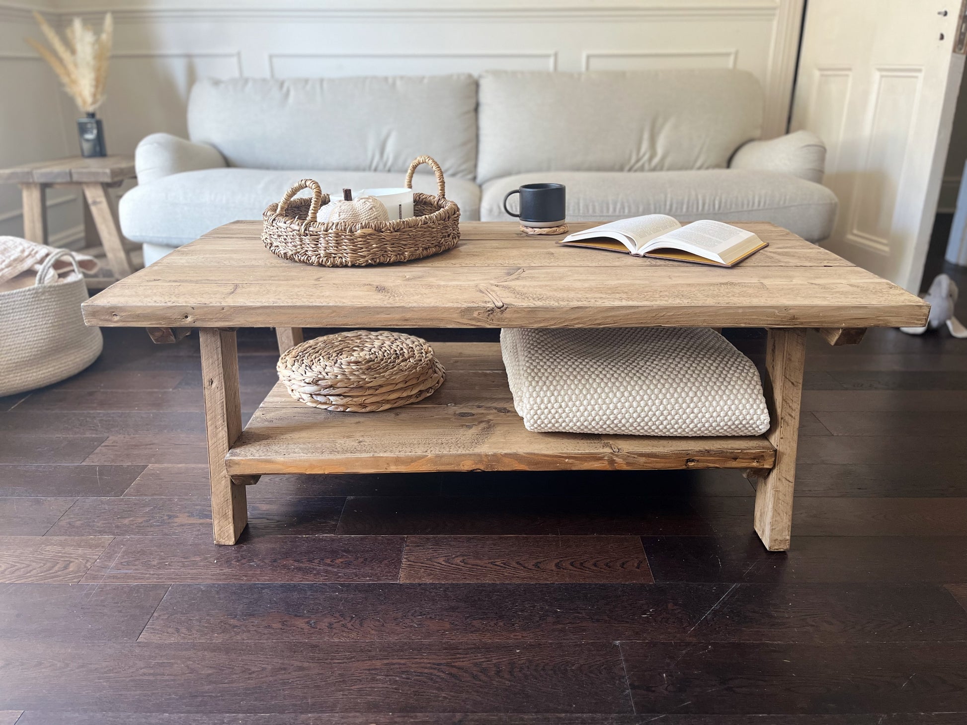Wooden coffee table with decorative items in a living room setting