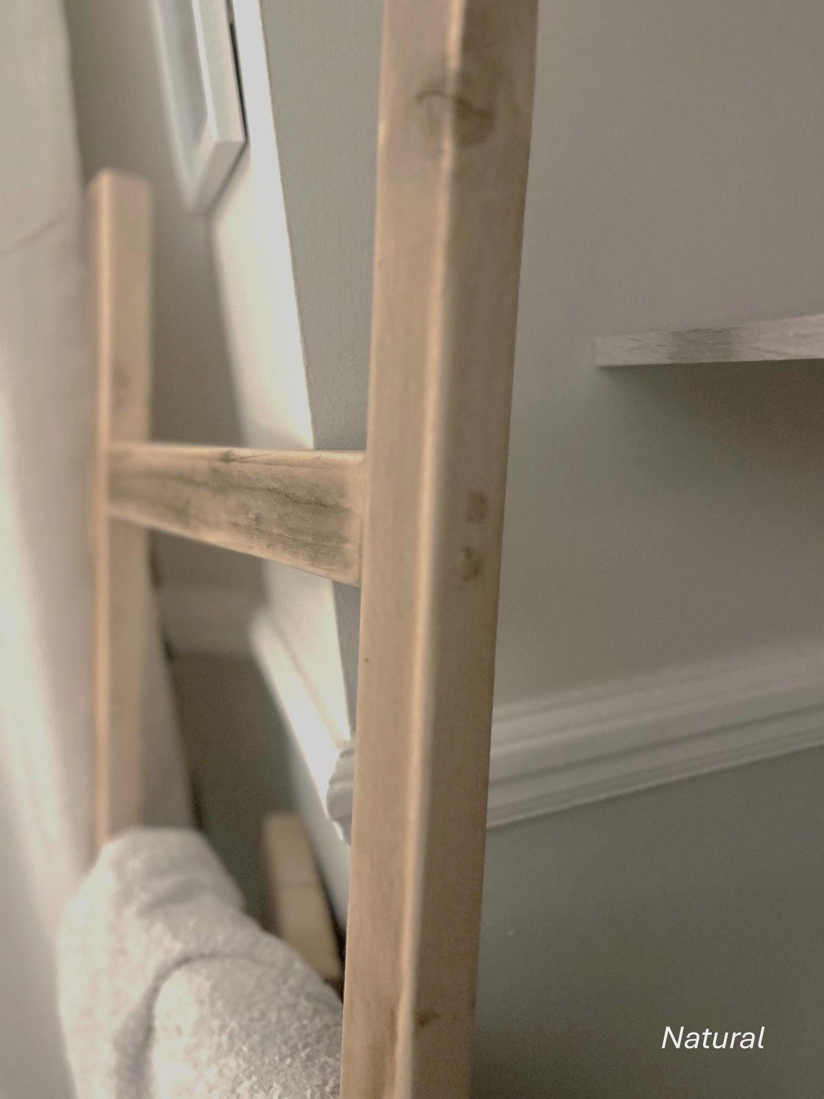 Wooden ladder against a neutral wall with a soft focus effect