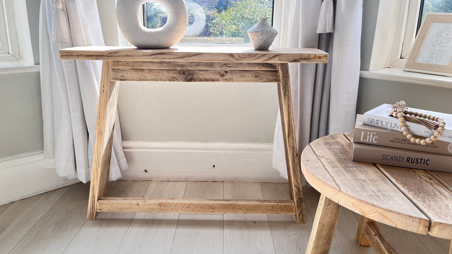 Rustic farmhouse wooden console table in a bedroom setting