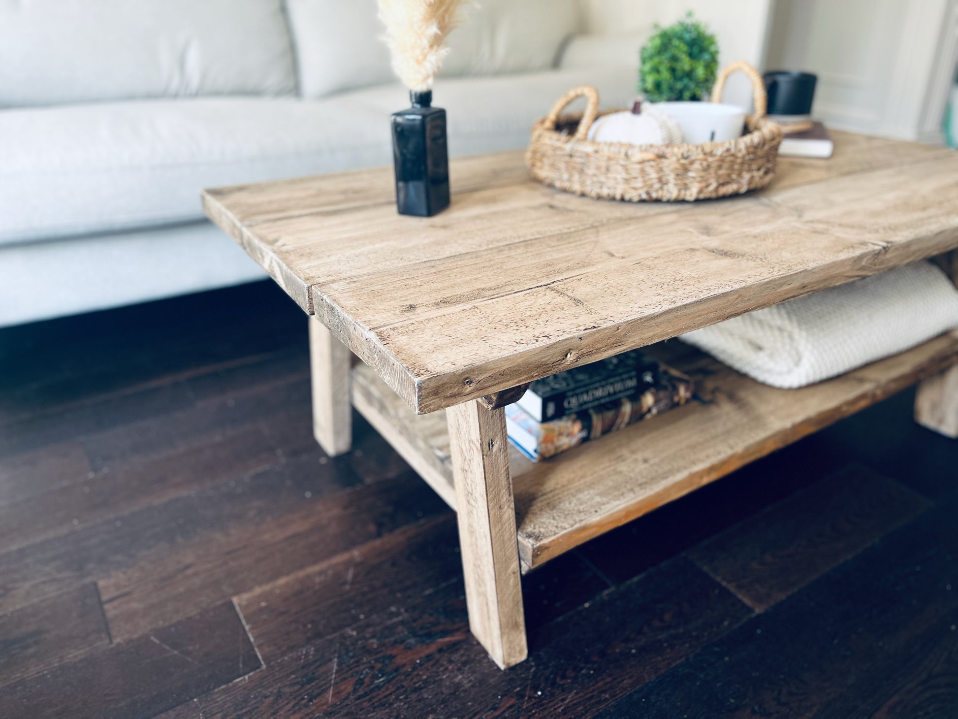 Wooden coffee table with decorative items in a living room setting
