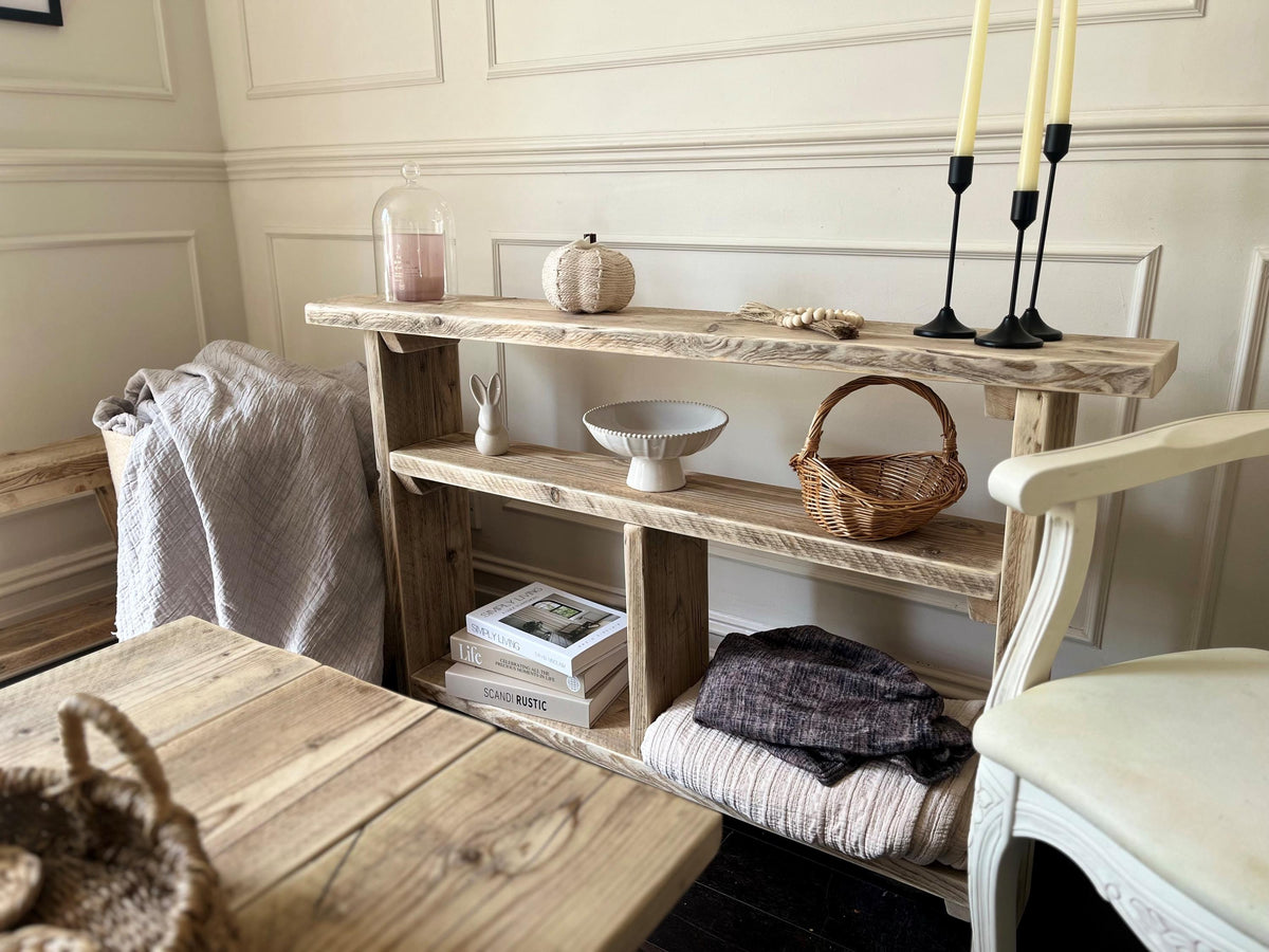 Nestled corner with wooden shelf, table, and chair against a neutral wall.