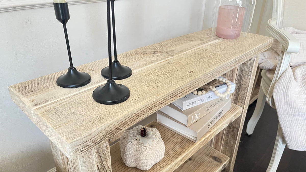 A farmhouse styled, rustic wooden bookcase, in a living room setting. (top view)