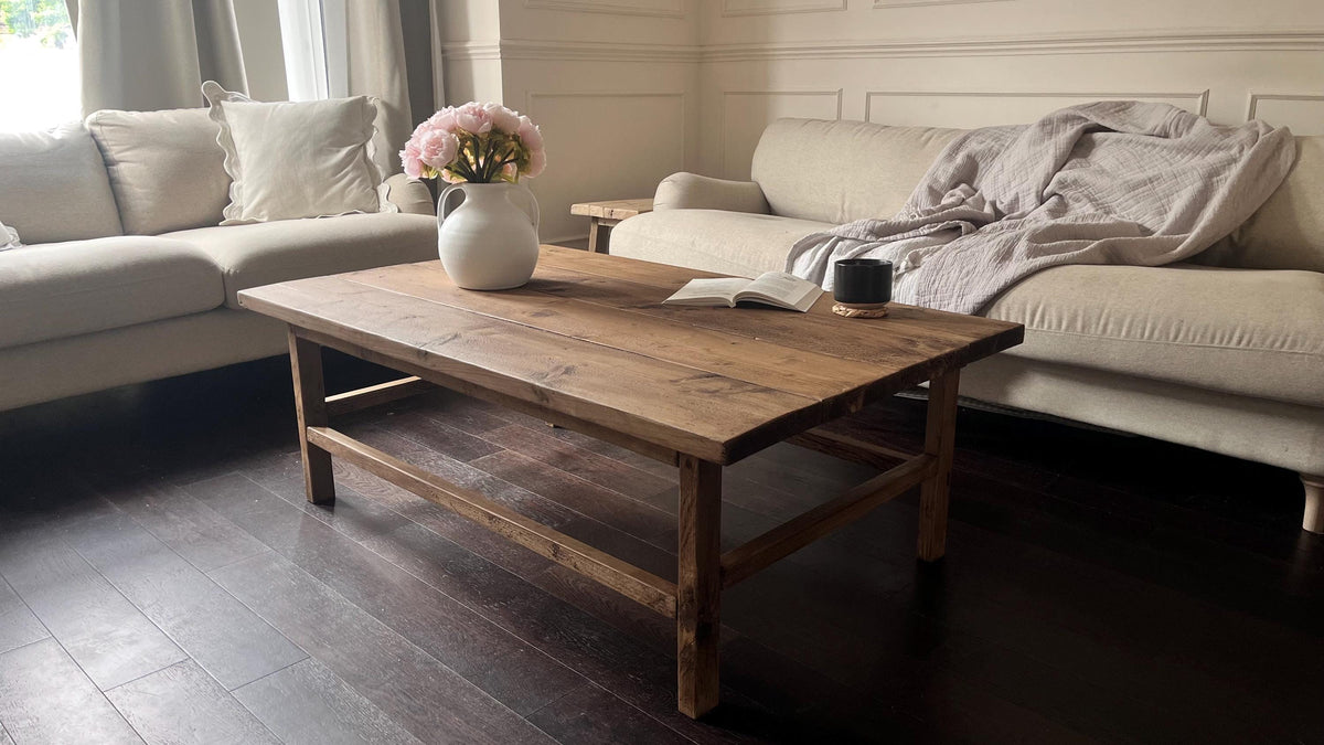 Living room with a wooden coffee table, beige sofa, and decorative elements.