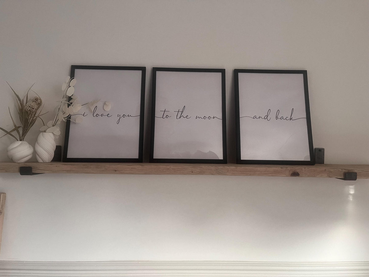 A farmhouse style rustic wooden console table with a bottom shelf, in a living room setting (front view)
