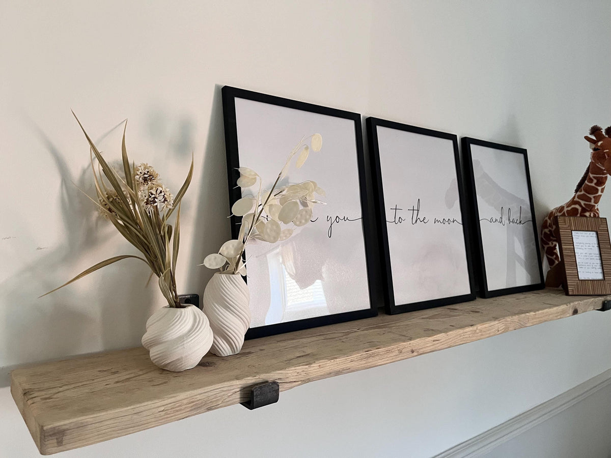 A farmhouse style rustic wooden console table with a bottom shelf, in a living room setting (front view)
