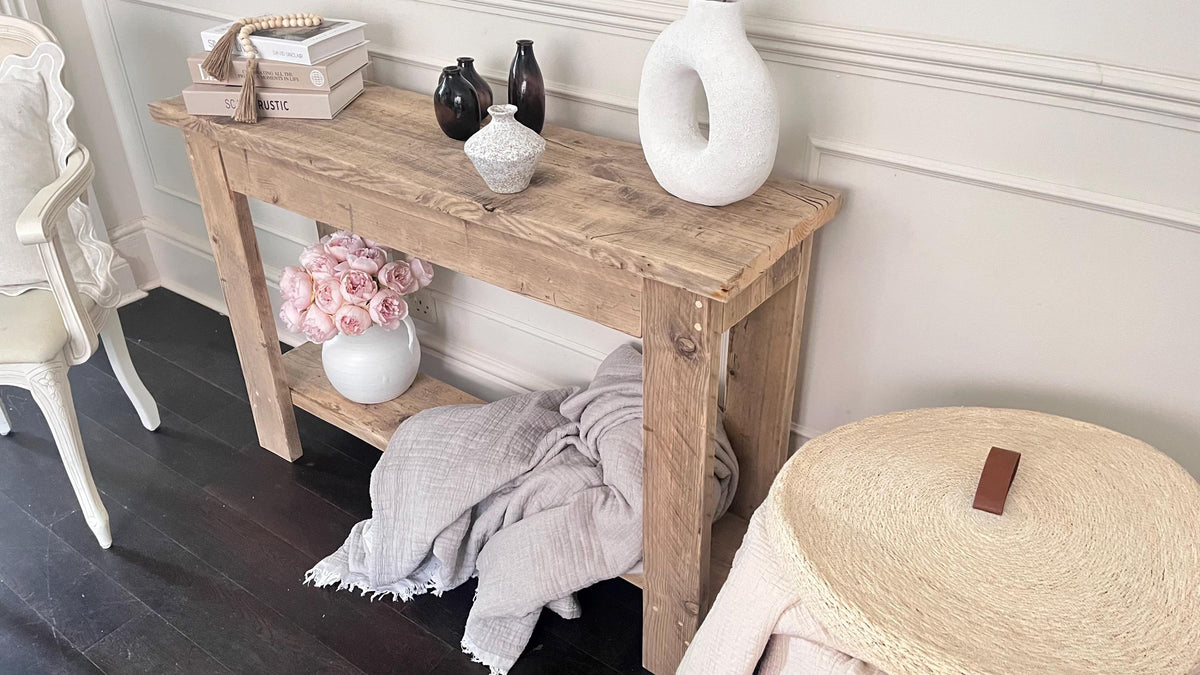 A farmhouse style wooden console table with a bottom shelf, in a living room setting (top view)